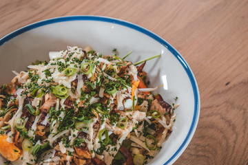 Delicious caesar salad and goatcheese salad on wooden table