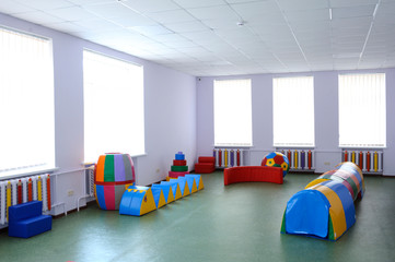 Interior of the physical therapy (rehabilitation) room for Down syndrome children: toys and...
