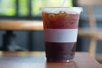 Close up glass of ice americano coffee on wood table