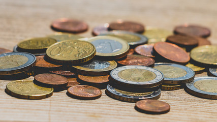 Euro coins on wooden texture