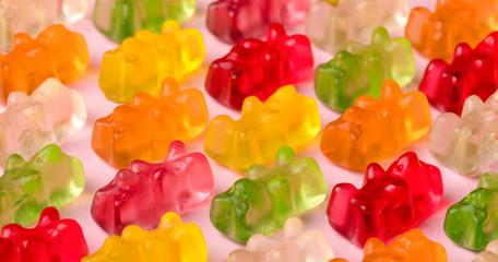 Gummy bears pattern over pink background, close-up image