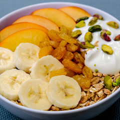 Healthy Vegetarian Breakfast Bowl of Muesli Fruit and Nuts With Yogurt