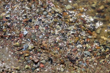 Close up view on a reflective water surface with waves and ripples in high resolution