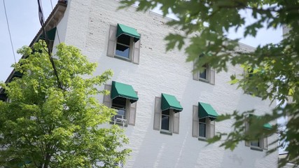 Establishing shot of second story white bricked store windows