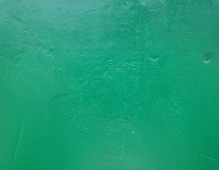 Green color paint old concrete wall with damages surface background