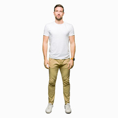 Fototapeta premium Handsome man wearing casual white t-shirt Relaxed with serious expression on face. Simple and natural looking at the camera.