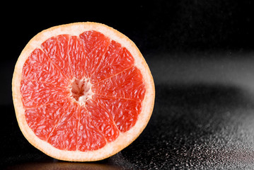 Grapefruit with water drops on black background. Citrus fruit. Healthy freshness food. fruit with vitamin