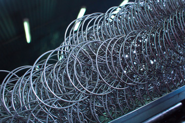Texture of metal wire. Production of springs for mattresses  - 278200859