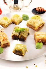 Middle eastern or arabic dishes. Turkish Dessert Baklava with pistachio on dishes