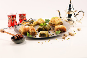 Middle eastern or arabic dishes. Turkish Dessert Baklava with pistachio on dishes