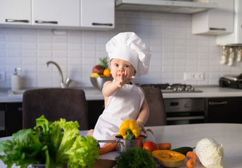  little boy, white chef hat, vegetables