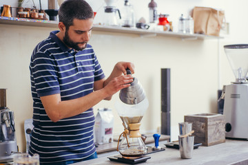 Drip coffee, pouring water over roasted in coffee shop