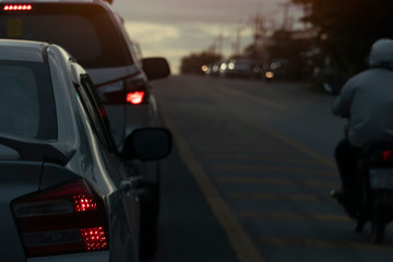 Bulled of cars and motorcycle on the road with light break at  crossroad. Car open light brake.