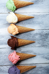 ice cream scoops of different colors and flavours with berries, nuts and fruits decoration on white background