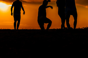 Young man playing football at the seaside