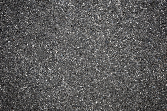 A smooth dark grey asphalt pavement texture with small rocks,Asphalt Dark Texture for Roads,Soil texture background - Powered by Adobe