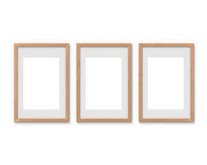 Set of 3 vertical wooden frames mockup with a border hanging on the wall. Empty base for picture or text. 3D rendering.