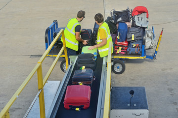 Loading luggage to the plane. - obrazy, fototapety, plakaty