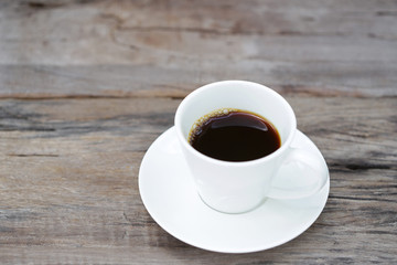 coffee in a white cup on old rustic wooden table 