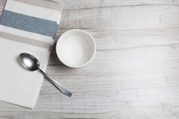 Empty clean bowl and spoon on the table,top view.Copy space