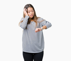 Young beautiful brunette woman wearing stripes sweater over isolated background Looking at the...