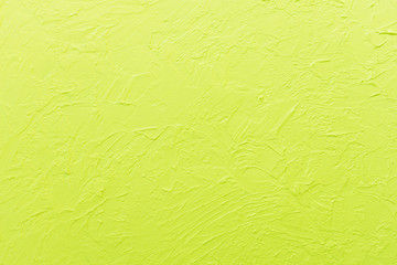 The texture of the plaster on the wall is lemon-yellow. Background.