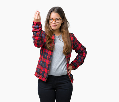 Young beautiful brunette woman wearing jacket and glasses over isolated background Doing Italian gesture with hand and fingers confident expression