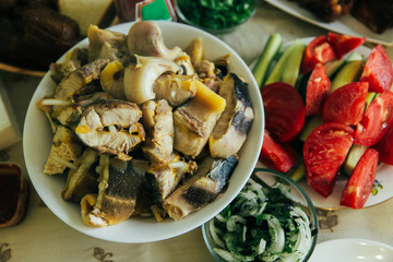 Salmon and vegetables, tomatoes-cherries and zucchini are grilling. Home Bbq. Nature, picnic, grass, fresh air. Cooking the fish.
