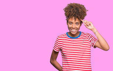 Beautiful young african american woman over isolated background Smiling pointing to head with one finger, great idea or thought, good memory