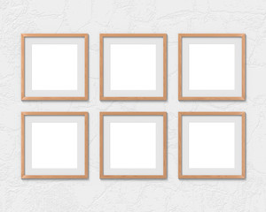 Set of 6 square wooden frames mockup with a border hanging on the wall. Empty base for picture or text. 3D rendering.