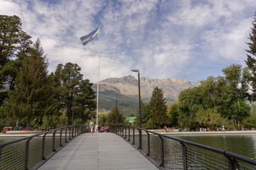 Scene view of Plaza Pagano against mountains in El Bolsón, Patagonia, Argentina