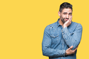 Young handsome man over isolated background thinking looking tired and bored with depression problems with crossed arms.