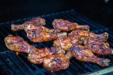 Delicious sizzling BBQ chicken on the grill
