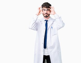 Young professional scientist man wearing white coat over isolated background Trying to open eyes with fingers, sleepy and tired for morning fatigue