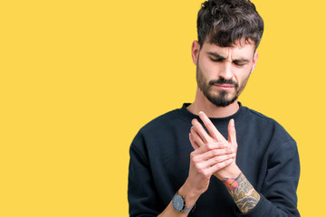 Young handsome man over isolated background Suffering pain on hands and fingers, arthritis...