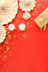 christmas or new year frame decorations in gold colors on red color background with empty copy space for text. Xmas, holiday and celebration concept for postcard or invitation. top view 