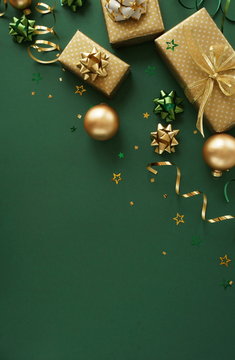 christmas or new year frame decorations in gold colors on dark green color background with empty copy space for text. holiday and celebration concept for postcard or invitation. top view 
