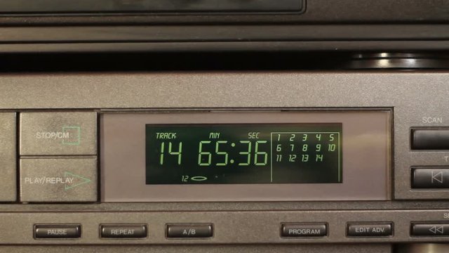 Pressing button open. Male finger presses cd player button.