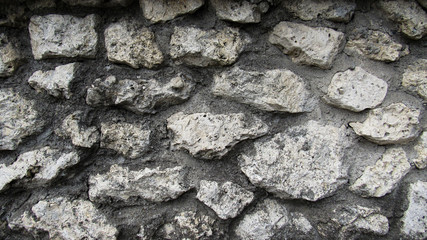 background of gray stone. the wall of a large old gray stone. stone wall texture