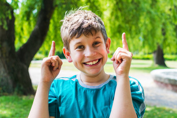 cheerful teenager boy outdoors in the summer