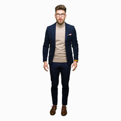 Fototapeta premium Young handsome business man wearing glasses afraid and shocked with surprise expression, fear and excited face.