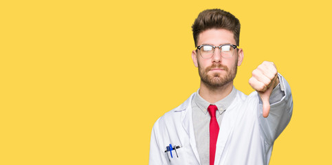 Young handsome scientist man wearing glasses looking unhappy and angry showing rejection and negative with thumbs down gesture. Bad expression.