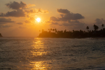 Fototapeta na wymiar sunset on the background of the Indian Ocean