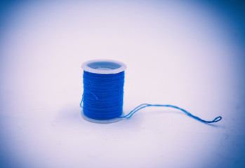 The abstract art design background of blue color thread put on white background,blurry light around