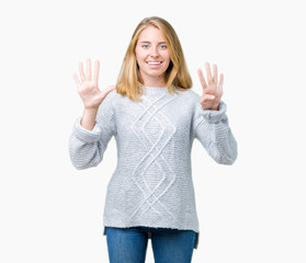 Beautiful young woman wearing winter sweater over isolated background showing and pointing up with...