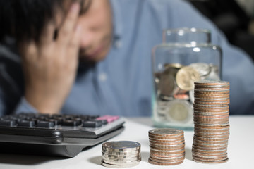 Asian man in blue shirt are stressed about money in the room.