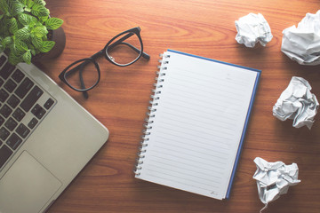In the room there are books, computers, trees, paper clips. And non-paper Put on an old wooden table