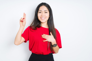 Beautiful brunette woman wearing red t-shirt over isolated background Swearing with hand on chest...