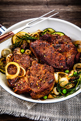 Grilled steak, baked potatoes and vegetables
