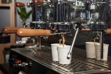 Warsaw Poland. 14. May. 2019. Coffee is poured into paper cups from the coffee machine.